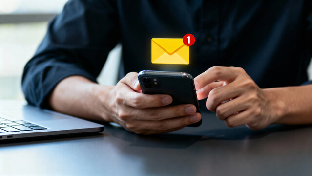 Person checking smartphone with email notification icon displayed above device