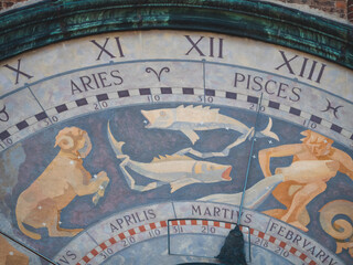 Torrazzo astronomical clock detail, Cremona, Italy with zodiac signs and calendar months like Aries, Pisces