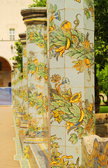 View of the colorful tiled columns of the cloister of Santa Chiara in Naples, Campania, Italy.