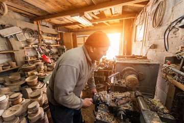 Senior Craftsman Using Wood Lathe Machine in Workshop Woodworking and Carpentry Manual Wood Turning Wood Shavings Crafting
