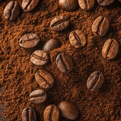 Close up overhead view of roasted coffee beans scattered across a bed of rich dark coffee grounds