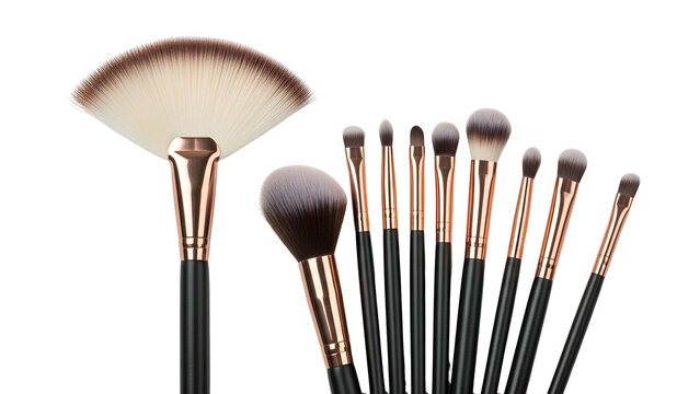Assortment of makeup brushes, black handles, gold ferrules, against a black background