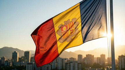 The Andorra flag waves gracefully against a sunset backdrop, with a city skyline and mountains. Perfect for travel blogs or tourism ads.