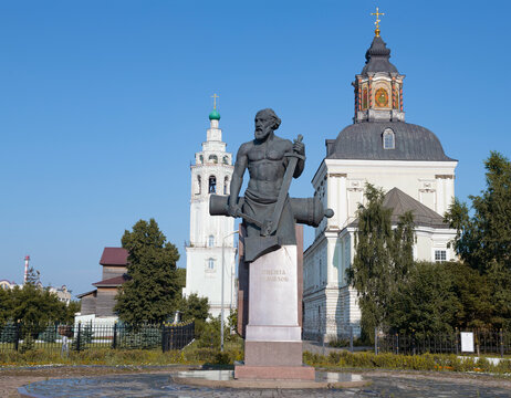 TULA, RUSSIA - JULY 15, 2024: Monument to Russian gunsmith Nikita Demidov on the background of Nikolo-Zaretskaya Church on a sunny July day