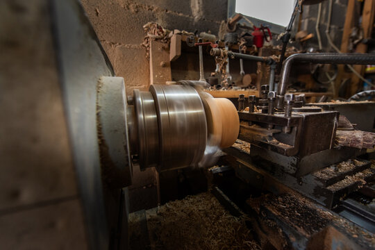 Woodworking Lathe Shaping Wood With Metal Tools In Workshop Carpentry Equipment For Wood Turning And Woodworking.