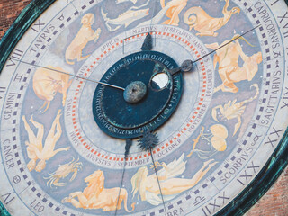 Astronomical clock face on Torrazzo bell tower in Cremona, Italy displaying zodiac signs and months
