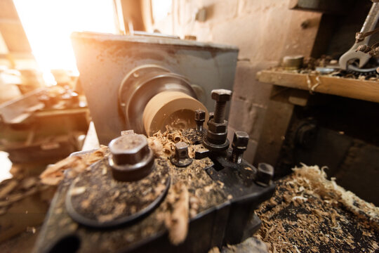 Woodworking Lathe Shaping Wood With Metal Tools In Workshop Carpentry Equipment For Wood Turning And Woodworking.