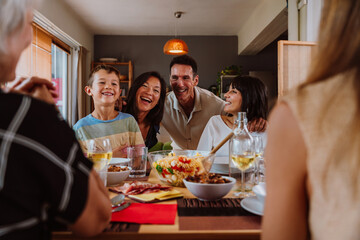 Family and friends reunion at home. Friends and family enjoying a pasta salad dinner party