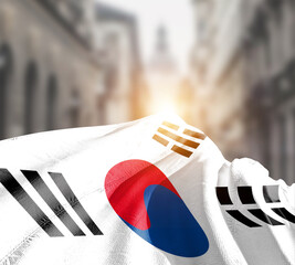 South Korea flag fluttering on blur street with building. Korean national flag for independence day.