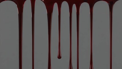 Thick red blood dripping down a grey wall in a continuous stream. A scary and gruesome concept for halloween horror themes or crime scene backgrounds and banners