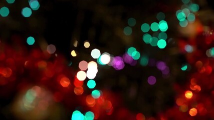 Abstract blurred background featuring festive lights in red gold and purple colors at night time