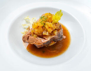 Braised pork neck served with pineapple and celery chutney over a soft potato mash, finished with light sauce. Clean high-key plating with natural light and minimal composition.