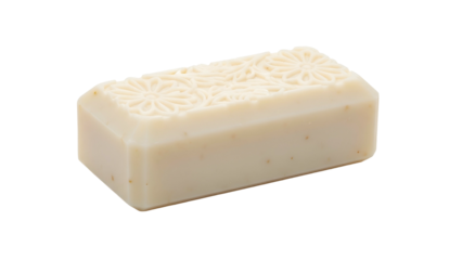 Cream-colored rectangular bar of soap with floral relief on top, isolated on black