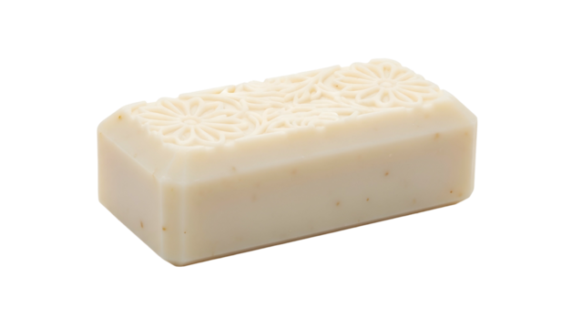 Cream-colored rectangular bar of soap with floral relief on top, isolated on black