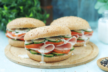 Bun sandwiches with salami and vegetables