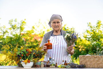 Grandmother makes tinctures from medicinal herbs. Selective focus.