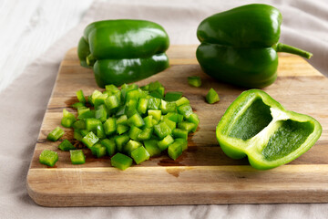 Organic Chopped Green Bell Peppers arranged on a Cutting Board, side view.