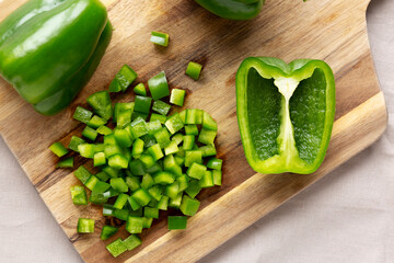 Organic Chopped Green Bell Peppers arranged on a Cutting Board, top view.