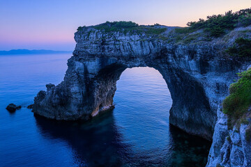 The natural stone arch of the Engetsu Island in Japan during twilight