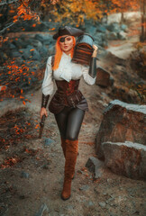 Art photo real person beauty woman one-eyed pirate holds in hands carries old style brown chest walking at island, armed with pistol gun. dark wooden box. Girl thief. game search for pirates treasure