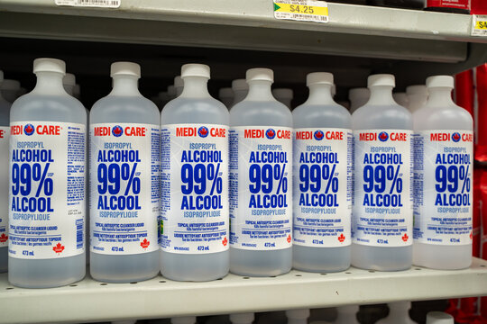 View of 99 percent isopropyl alcohol bottles on store shelf. Toronto, Canada - November 26, 2025.