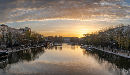 Paris, France - 11 08 2025: Ourcq Canal. Panoramic View of the Villette Basin and buildings around at sunset and golden hour