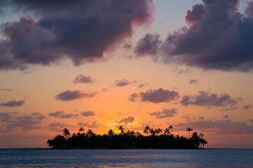 Tropical Island Sunset with Palm Trees and Dramatic Sky