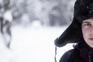 Portrait of a child wearing a winter hat with earflaps