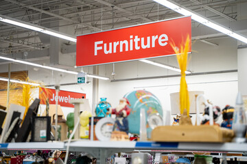 Obraz premium View of furniture section sign hanging above store aisle.