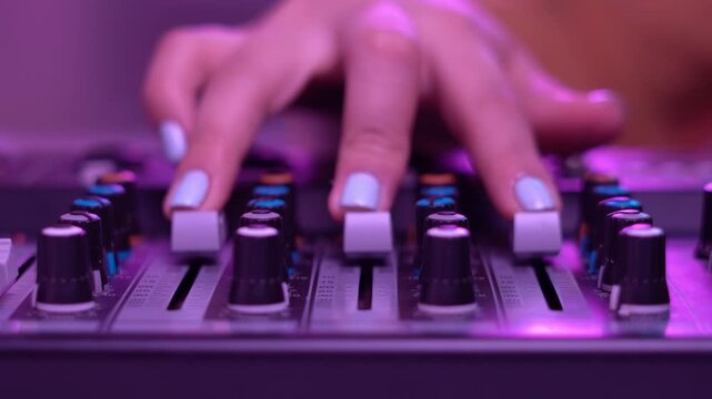 A calm hand shifts mixer elements as soft lighting creates a warm ambient environment in the workstation.