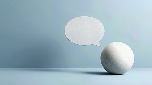 White chat bubble and stone ball on blue minimalist background.
