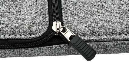 Close-up of a gray fabric bag with a black zipper pull, partially unzipped