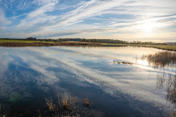 The sky reflecting in a small lake