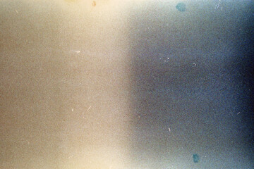 Blank grained film strip texture background with heavy grain, dust and light leak.