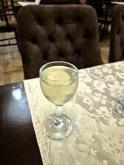 A glass of alcoholic beverage is on the table.