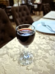 A glass of alcoholic beverage is on the table.