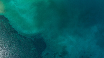 Obraz premium Aerial view of the azure and turquoise surface of water. Sea concept. Ideal for backgrounds, textures and patterns of tropical seas.