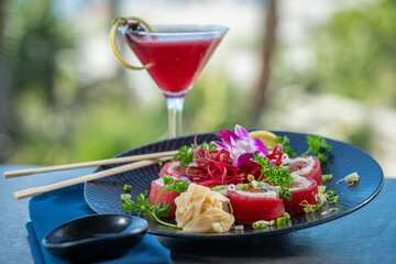 Tuna wrapped sushi roll with berry cocktail.