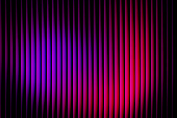 Abstract background of vertical corrugated curtain or panel illuminated by dramatic purple and red neon stage lighting creating a vibrant texture