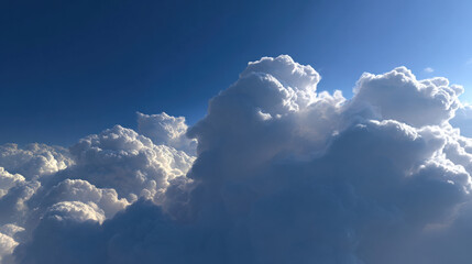 Fluffy white clouds floating in deep blue sky in sunlight