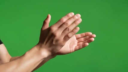Enthusiastic hands clapping against a vibrant green screen backdrop, ideal for adding applause or celebration to any video project