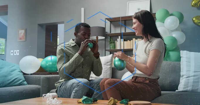 Man gesturing initiating couple inflating green balloons while tying and inspecting party 30 foil