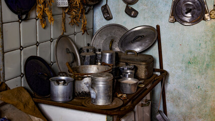 Vintage Kitchen Corner with Traditional Aluminum Cookware and Hanging Herbs