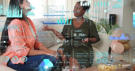 Two women sitting on couch starting finance chat while data charts overlaying around gestures - Powered by Adobe