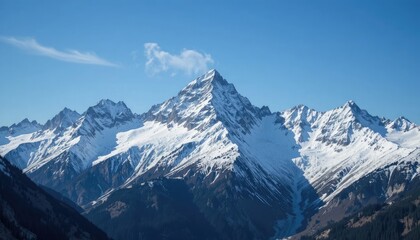 Majestic snow capped mountains under clear blue skies for adventure travel stock