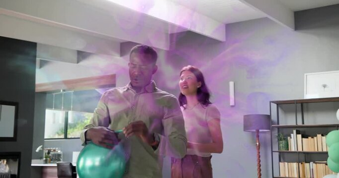 Man blowing teal balloon and woman fastening clusters, purple overlay guiding 30th birthday setup