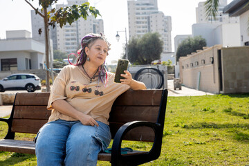 Serious mature woman with dreadlocks and curvy body checking mail while holding small dog