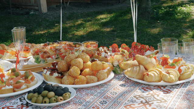 A furtshet features a standing buffet with assorted appetizers and drinks arranged for easy self-service.