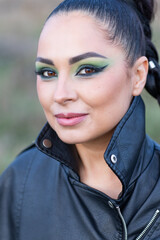 girl with artistic makeup in leather shorts