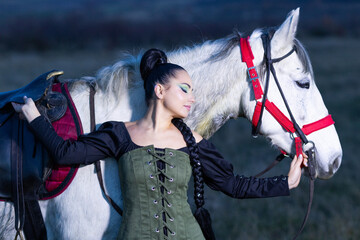 Charming European lady posing with a majestic white horse in an open field, symbolizing freedom, calmness, and connection with nature.
